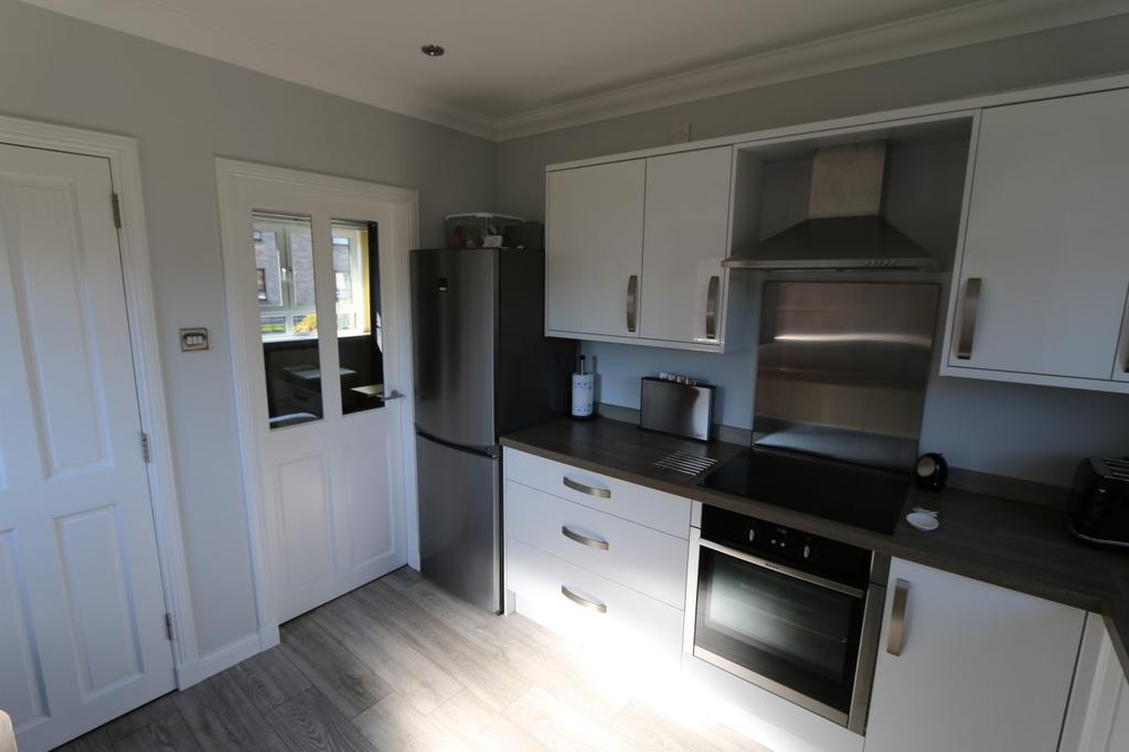 Kitchen which is situated to the rear of the property with an outlook over the rear garden.