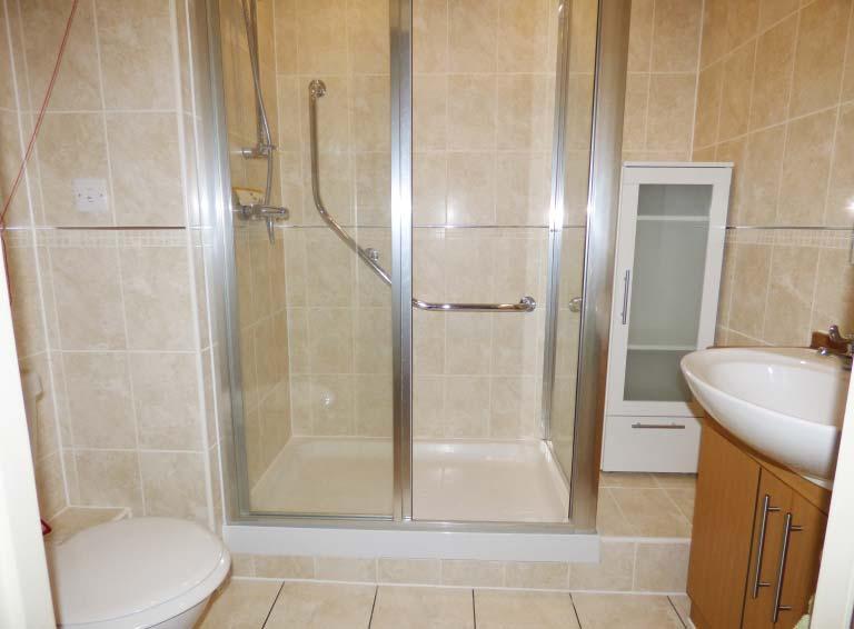 Shower Room 7 x 5 7 approx. A modern suite of walk-in oversize shower cubicle with fitted hand rail and shower unit. Close coupled w.