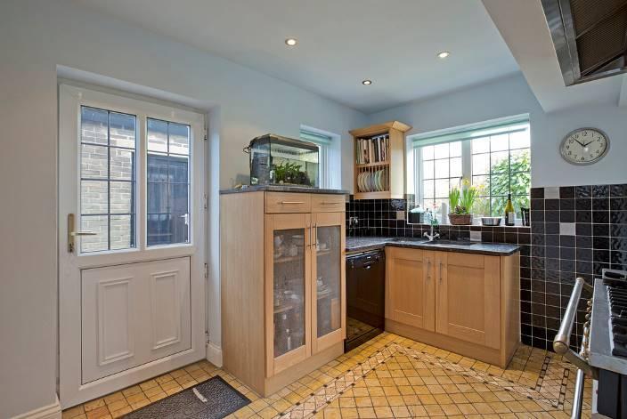 96m) having a twin aspect with a bay window to the side and a window to the front, built in bookcase with storage cupboards below, ceiling cornice, feature fireplace with attractive oak surround and