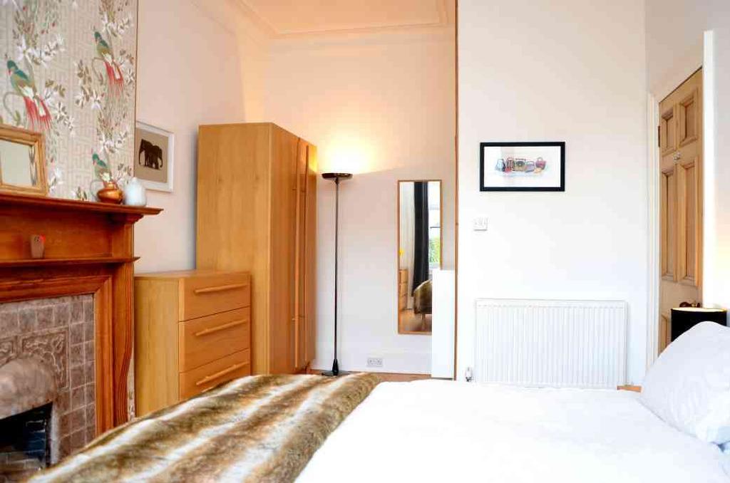 access to rear garden; double bedroom 1 with feature fireplace; double bedroom 2; double bedroom 3 which is being used as a