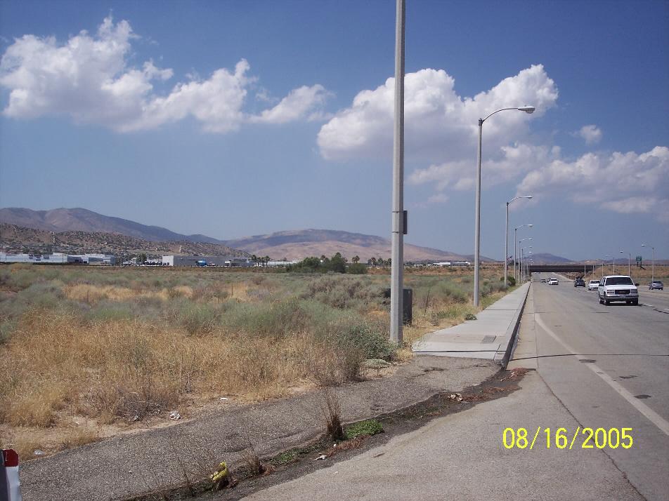 From corner of Division and P-8 PALMDALE looking West towards Freeway. 12.74 ACRES WEST FREEWAY VISIBILITY (Buildings in view are Palmdale Auto Mall) Corner of the property looking South across P-8.