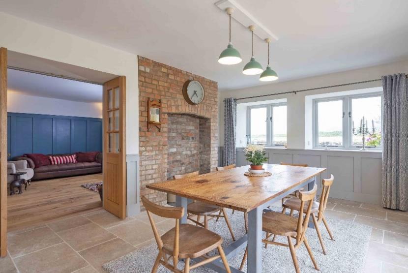 Heated natural limestone flooring throughout, full height brick fireplace creating a feature in the dining part of the room.