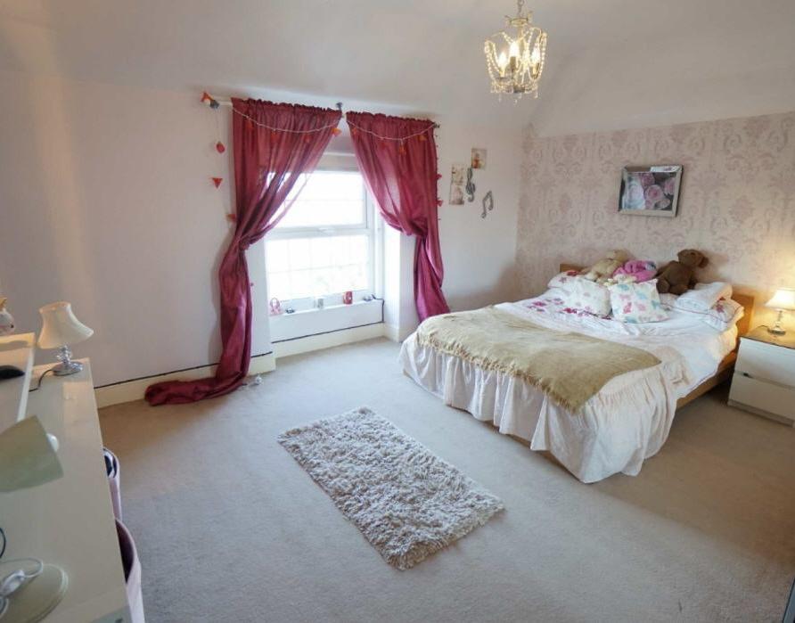 Double panelled radiator; picture rail; large upvc double glazed bay window to front enjoying sea views.