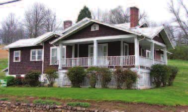 Older farm style home has country front porch, living room, dining room, kitchen, large bath and 2 bedrooms.