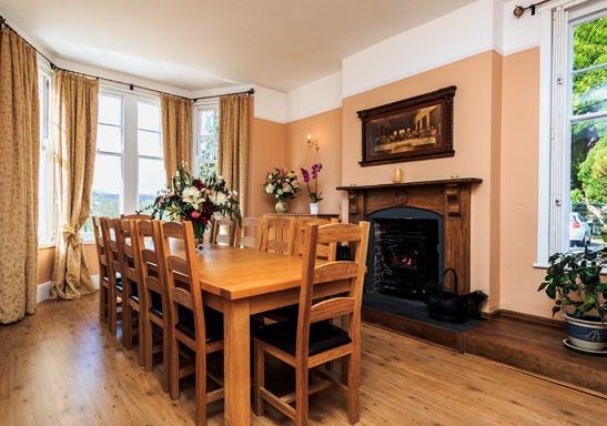 Adjacent to this room is the formal dining room that enjoys a bay window with views over the valley and a smart fireplace with wood surround and a wood burning stove providing a warm focal point.
