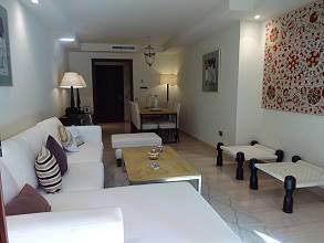 The apartment is bright and modern with access to the large communal pool and