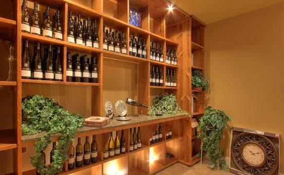 Lower Level Wine Room: A wine collector s dream - granite counter and custom built-in shelving to house many bottles of wine.