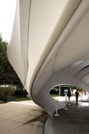 Louvers in the pavilion's ceiling bring an interplay of light and shadow into the space as the sun changes position during the day Exterior lighting highlight the pavilion at night The interior of