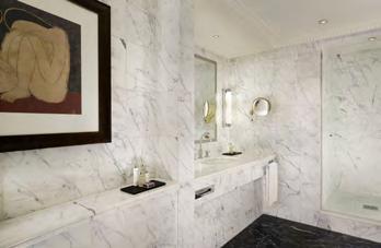 The suite is equipped with a fully marbled ensuite bathroom with a walk-in shower and bathtub as well as a