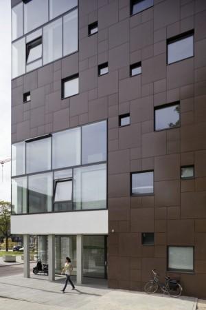that it resembles a punch-card, and will be covered with dark brown panelling, which gives the building a natural feel The ground floor comprises support facilities for the students, technical areas