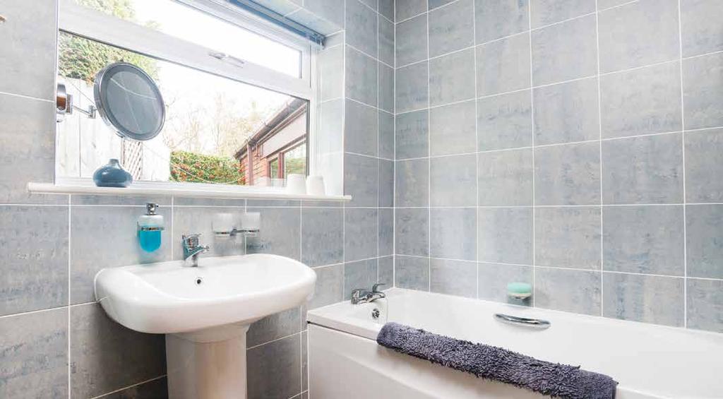 From the hallway leads to the main family bathroom with a contemporary white suite, the bathroom comprises bath,