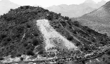 In 1914, Coach Pop McKale s football team was so successful that discussions began to honor the team and the University by building a huge A on Sentinel Peak, west of downtown Tucson.