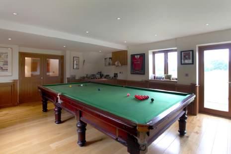 The Drawing Room provides an elegant space for formal entertaining with a stone fireplace, solid oak flooring and French windows opening to the terrace and the Billiard/Games Room is wood panelled