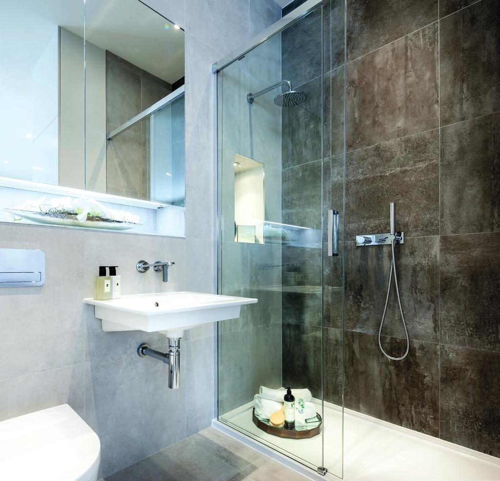 BATHROOMS Bathroom Villeroy & Boch wall hung porcelain basin with surface mounted chrome Crosswater mixer tap Bespoke recessed mirror cabinet with internal glass shelving, shaver socket and sensor