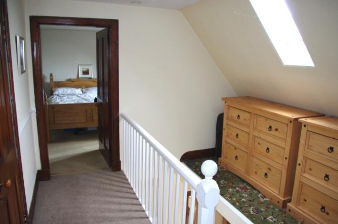 UPPER FLOOR:- The attractive stairway leads to