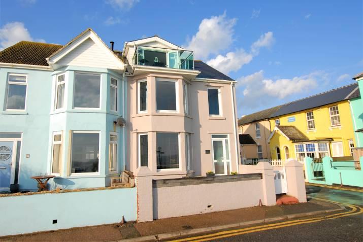 including a sitting room, kitchen/dining room, 3 bedrooms (master with en-suite and sea facing