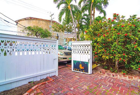 This home retains its original charm, with handcarved balusters, hand- tooled furniture inside and the picket fence that retains its gingerbread charm,