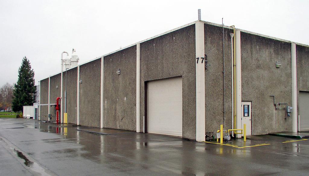 The building includes a one (1) ton overhead crane in place. Windows on ground floor and above, an alarm, two (2) grade level roll-up truck doors.