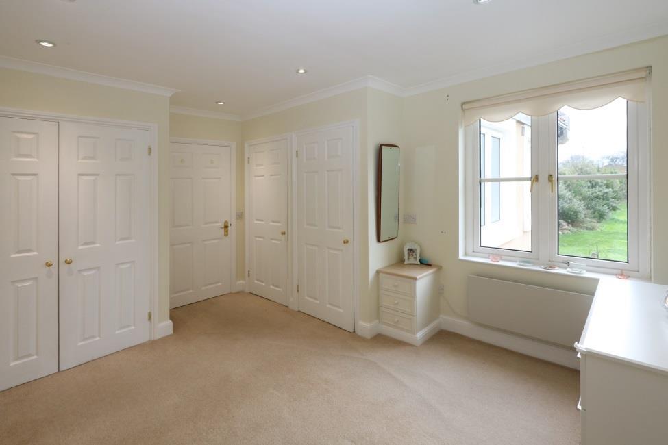 Bedroom 2 13 7 x 1 5 Fitted with a range of wardrobes. Window to side overlooking the communal garden and orchard beyond.