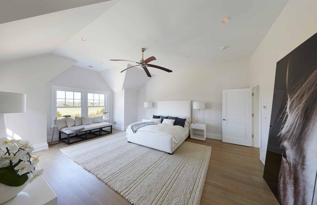 MASTER SUITE The opulent master suite has soaring ceilings, a lounge area, and access to a