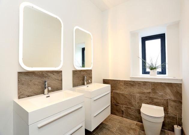 with LED lit mirrors above and WC. Opaque side facing window, attractive tiling, heated towel rail.