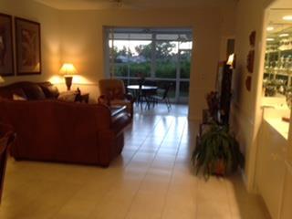 Open concept unit includes the eat in kitchen, living/dining room with glass shelved mini bar, front