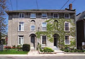 It is a three-storey stone house with two doors on Gore and one on Wellington St. ere are semi-circular arched entrances with recessed doors and a large blind arch above each.