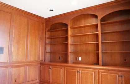 Library: Hardwood floors, cherry paneling & bookcases, French doors.