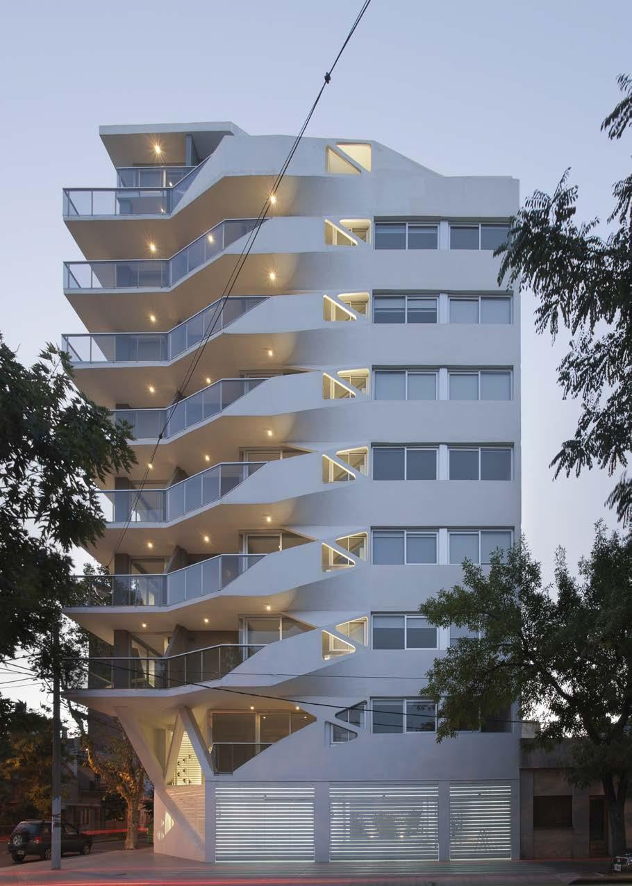 Right Night Time East Elevation 3 Street and Entrance At ground level, concrete cross braces receive the diagonal deviations produced by the balconies, creating a double-height urban corner free of