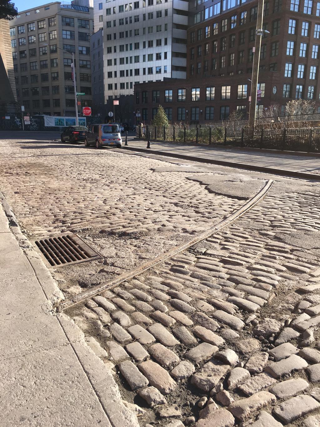 This is a picture of Water St. in Dumbo, a cobblestone street that shows how little this neighborhood has changed.
