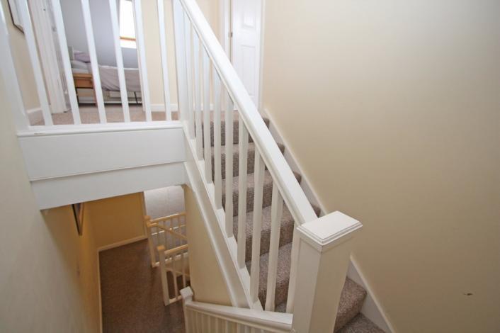 The stairs and landing are carpeted and have painted walls, balustrades and ceilings. There are doors off to the Master Bedroom and Bedroom 3.