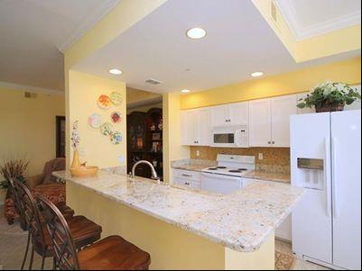 for dining and entertaining. Lovely kitchen with a breakfast nook that overlooks the sunroom/lanai.