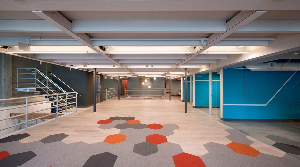 A combination of polished concrete floors with carpet squares create a sophisticated, modern