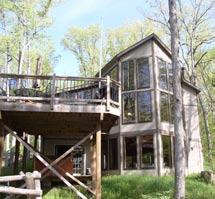 This 2-bedroom, 2-bath chalet rests 3.1 acres on peaceful Lake St.