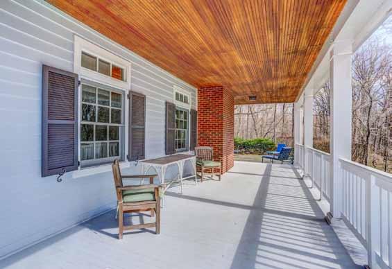 french doors flanked by large wooden shutters and inviting porch swing; wired for sound;