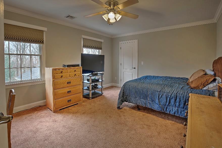 with organizers, wall to wall carpeting, and crown molding.