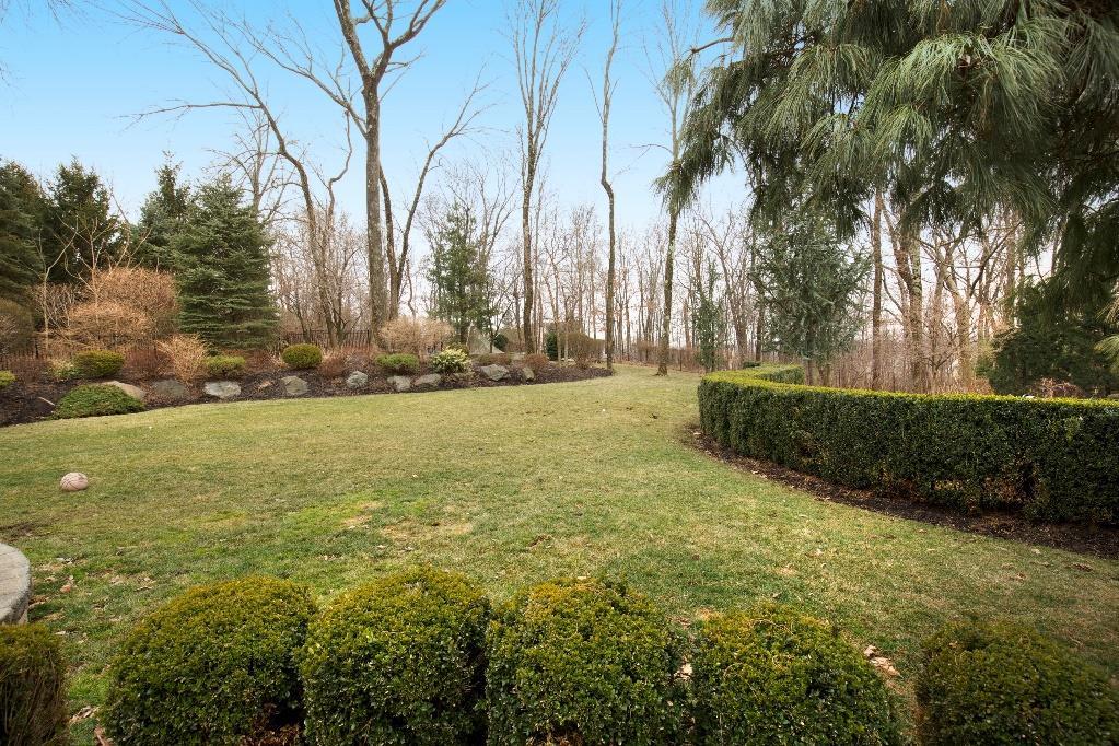 private yard boasts three tiered custom landscaping,