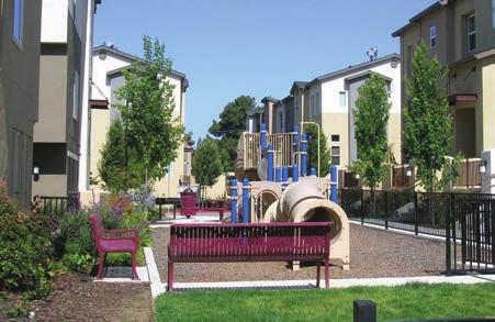 density developments. In this example, the tot lot is located in a central location and accessible by the residential units and includes seating for adults supervising their children.