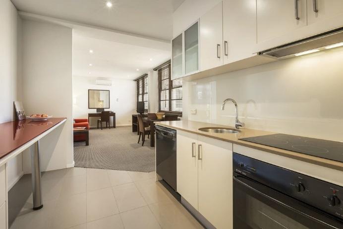 The relaxed living area contains a sofa, LCD TV with Foxtel and work desk, whilst the fully equipped kitchen provides a cooktop, oven and fridge, and dining table.