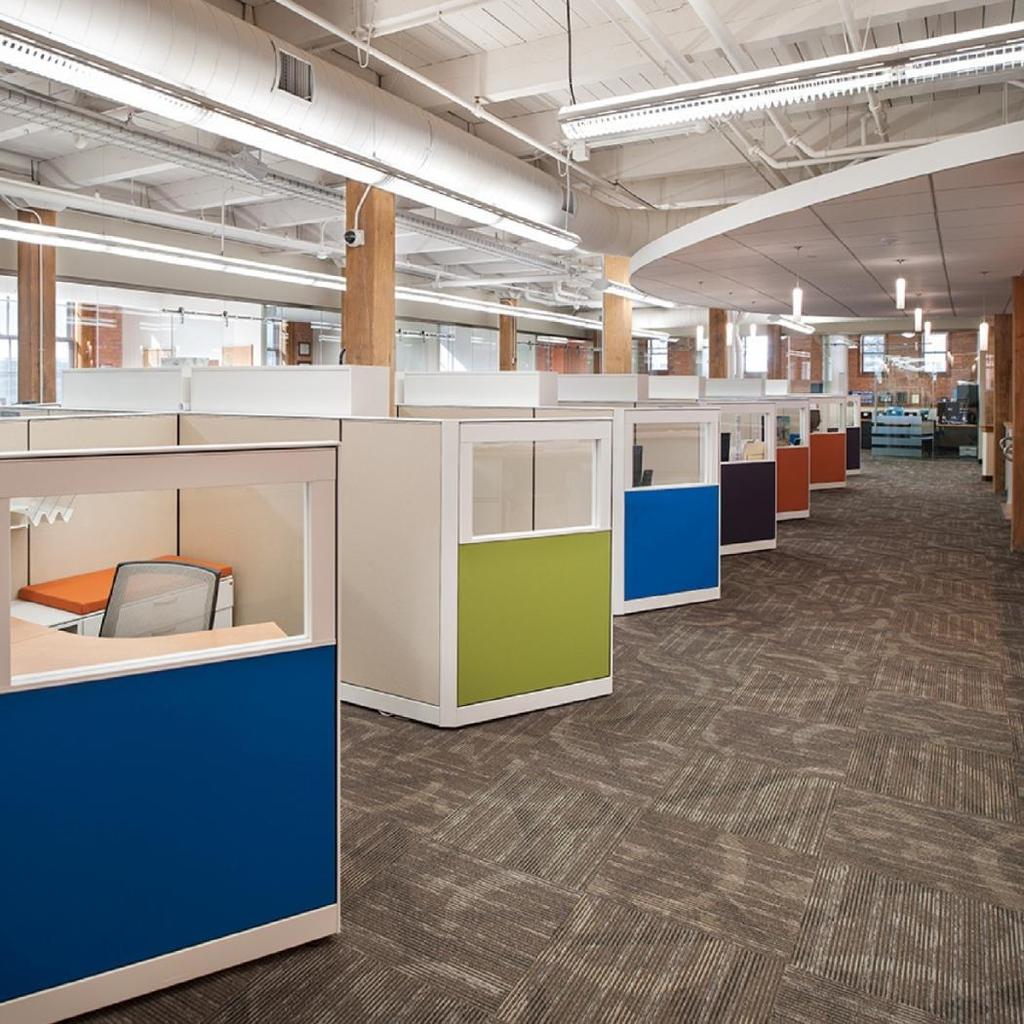 OFFICE ENVIRONMENT Randomized color blocks and glass panels are used in the face forward design of the cubicles, creating an active work environment.