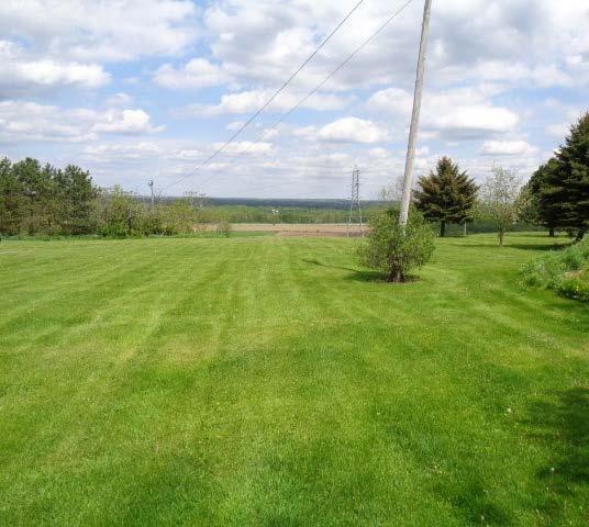1 acre building lot with large pond overlooking Sugar River with drilled well & 100 amp electric on site.