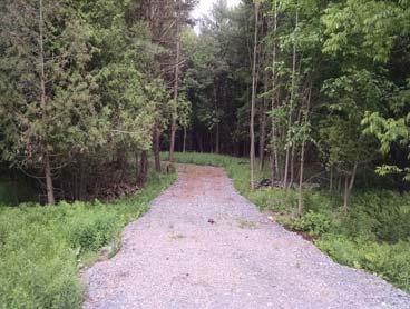 89 acres w/ 500 frontage on Crystal Creek with 26 Prowler camper & pole barn. On trails.