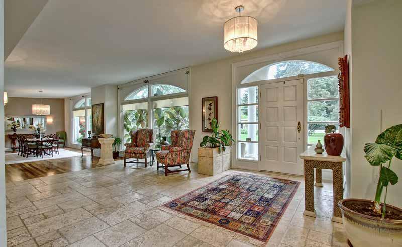 Step through the front door into the grand foyer spanning the length of the main house.