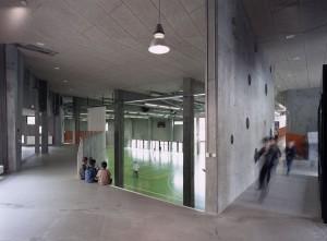The new school building at Bakkegaard School creates a new centre in a former campus situation It stands on what was the old school yard, making room for an indoor sports arena that is also the
