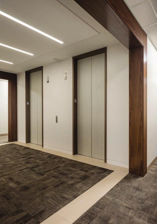Corridors with new ceiling grid and LED light fixtures Elevator