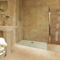 Contemporary designer bath, sink and low flush WC Separate walk in or over bath shower, thermostatic shower valve Fully tiled En-suite Walk in