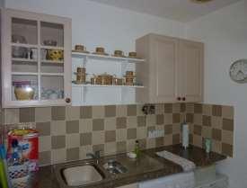 tiled between cupboards, laminated worktop,