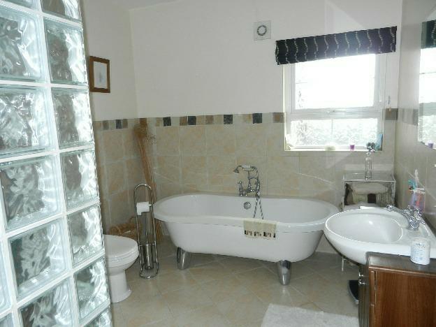 BATHROOM: 10' 4" x 8' 10" (3.15m x 2.69m) Contemporary roll top bath with mixer tap and shower fitting.