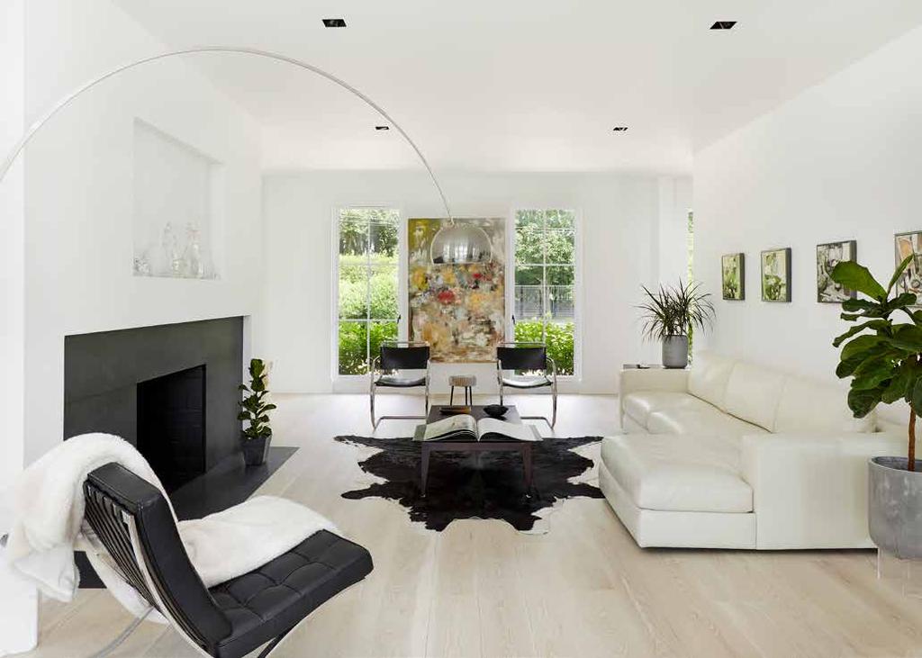 The neutral color palette works well with vaulted ceilings to create an open flow between each of the living rooms.