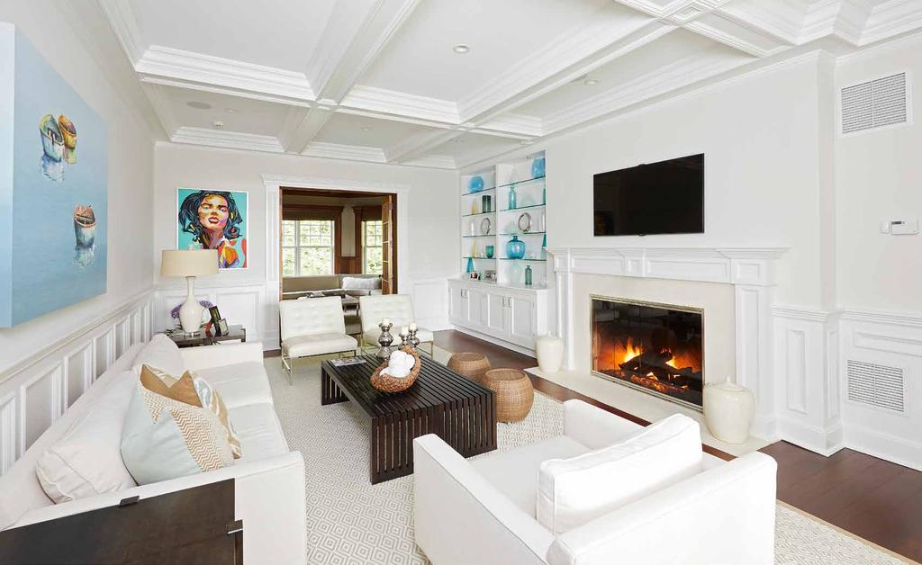 LIVING ROOM The living room features a fireplace, coffered ceiling, and french doors that